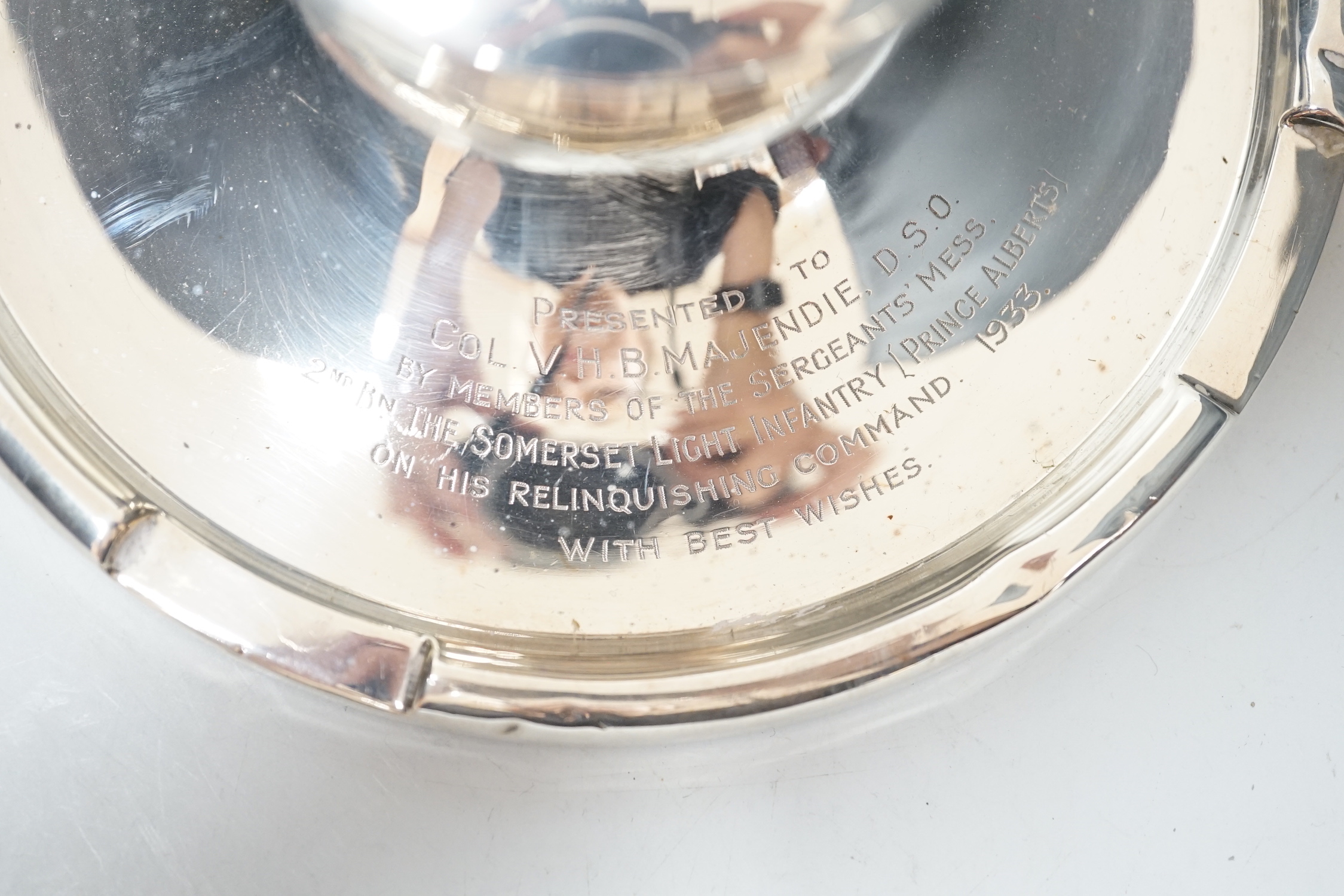 A George V silver mounted capstan inkwell, with Light Infantry related inscription, A & J Zimmerman, Birmingham, 1931, diameter 17.7cm.